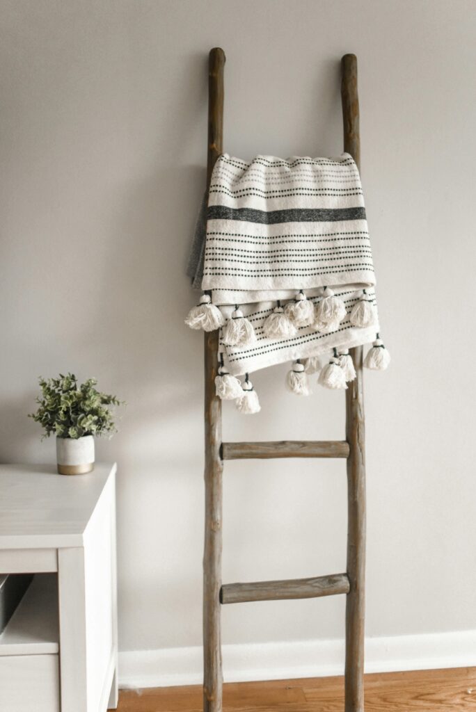 pexels-photo-1125131-1125131 A modern decorative ladder with a hanging blanket in a cozy home setting.